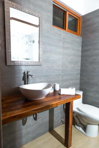 a bathroom with a sink and a toilet at Olas y Arena in Vichayito
