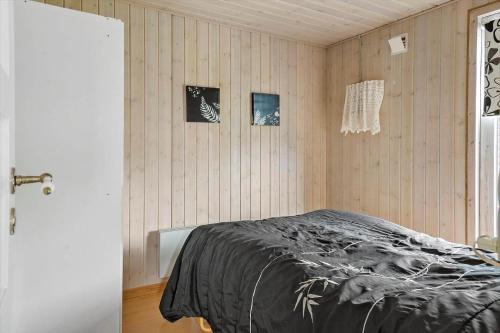 een slaapkamer met een bed en twee schilderijen aan de muur bij LF11171-Struer-Klintevej-14 in Struer