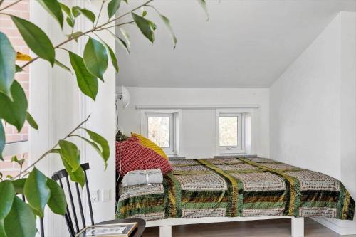 a bedroom with a bed in a white room at LF10229-Thyholm-Skovstjernevej-9 in Thyholm