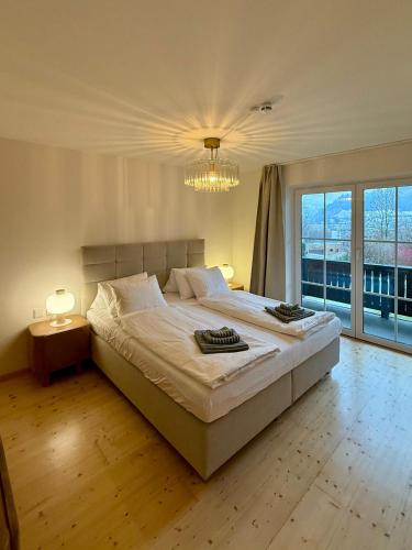 a bedroom with a large bed and a large window at Haus Monterosa in Sankt Johann im Pongau