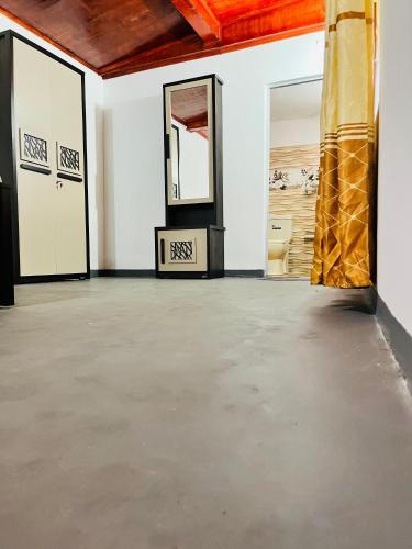 an empty room with two mirrors and a yellow pillar at Azure Coast Villa in Ahangama