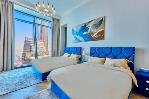a bedroom with two beds and a large window at Private room in BURJ KHALIFA facing 3BR luxury apartment in Downtown Near Dubai Mall Metro in Dubai