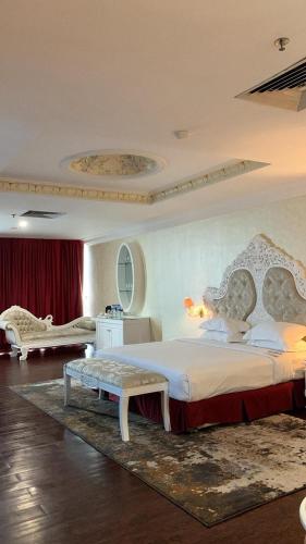 a bedroom with a large bed and a table at Pacific Palace Hotel in Nagoya
