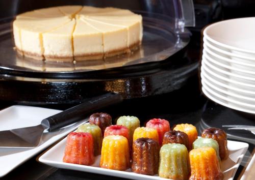 a plate of chocolates on a table with a cake at Grand Hotel Saint Michel in Paris