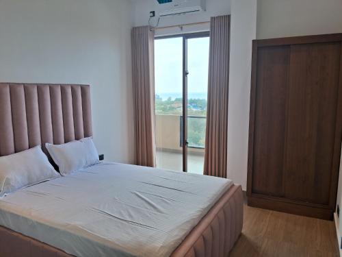 En eller flere senge i et værelse på Lavania Ocean View Residencies