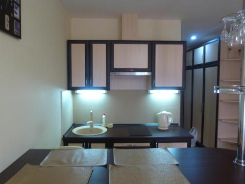 a kitchen with a sink and a table with chairs at New Gudauri Sunny studio in Gudauri