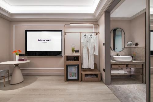 a bathroom with a sink and a mirror at Mercure Chengdu Dongjiao Memory in Chengdu