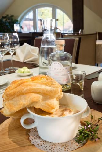 a table with a bowl of soup and a sandwich at Sagadi Manor Hotel in Sagadi