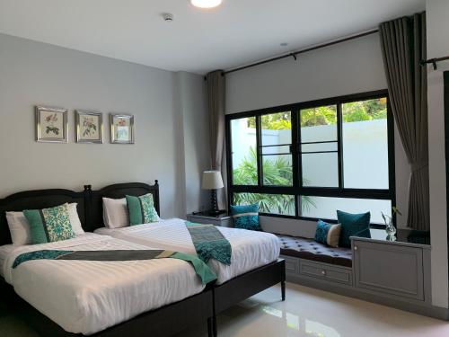 En eller flere senge i et værelse på Triple Trees Residence former Double Tree Residence