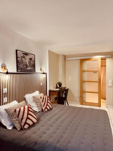 a bedroom with a large bed with two pillows on it at Hôtel le Nid in Argelès-sur-Mer