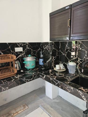 a kitchen with black and white marble counter tops at Pradeepa Villa in Weligama