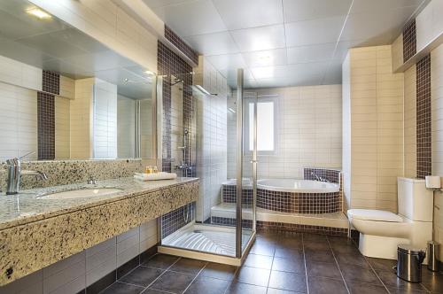 a bathroom with a tub and a toilet and a sink at Cerkezkoy Business Hotel in Cerkezkoy
