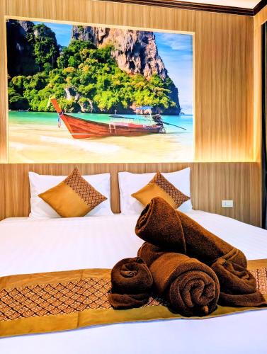 a bed with a picture of a beach and a boat at Diamond Cave Resort in Railay Beach