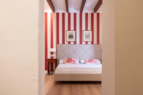 - une chambre avec un lit à rayures rouges et blanches dans l'établissement Hotel Rural S'Olivaret & Spa, à Alaró