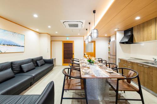 a living room with a table and a couch at YOKOHAMA STAY PREMIER in Yokohama