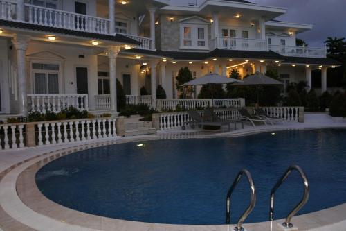 a large house with a swimming pool in front of it at Godiva Villa Phu Quoc in Phu Quoc