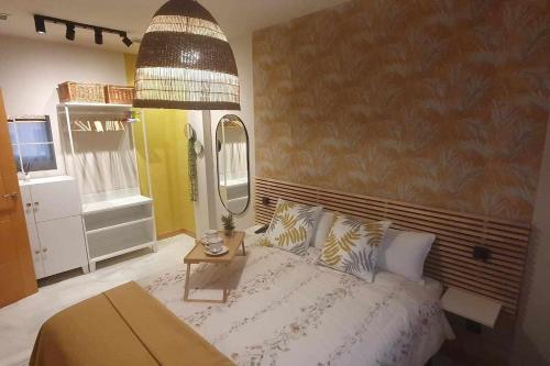 a bedroom with a bed and a large mirror at Apartamenticos Studio 98 in Zaragoza