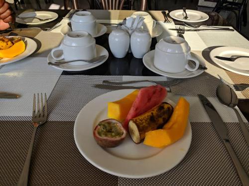 a table with a plate of food on a table at Saala Hotel Limited in Gatunga