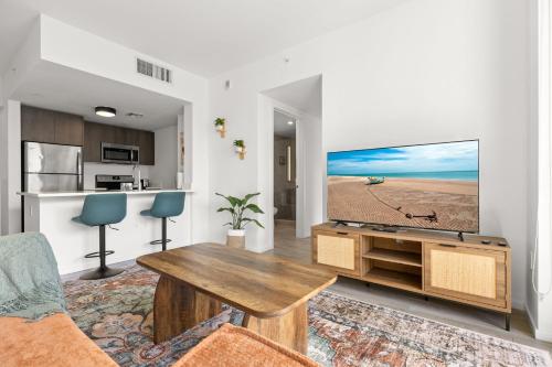 a living room with a large flat screen tv at Breezy Stays Luxury Residences - near Kaseya Center in Miami