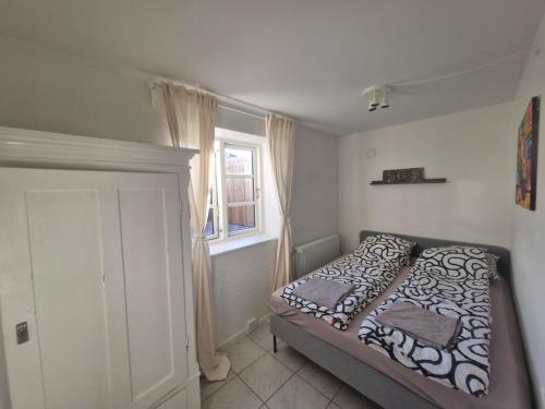 a bedroom with a bed and a window at Cozy Airport stay in Copenhagen