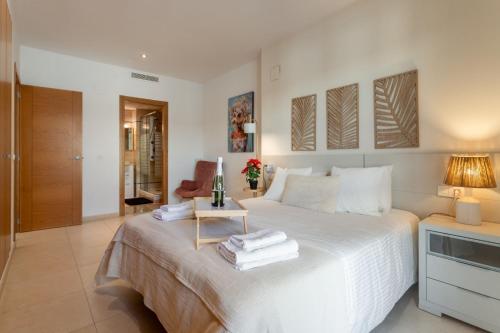a bedroom with a white bed with a side table at Valencia Beach Vibe by Vireta Suites in Valencia