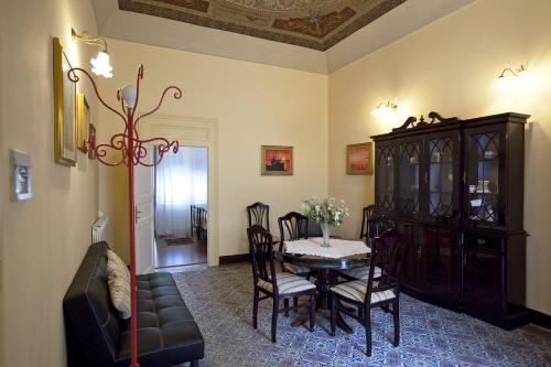 a dining room with a table and chairs and a cabinet at Casa Signorile in Trapani