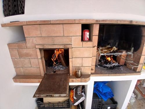 a brick oven with two fires in it at OPA Hostel Milfontes in Vila Nova de Milfontes