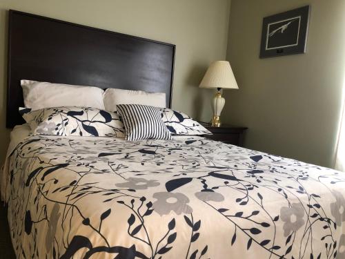 a bedroom with a bed with a black and white comforter at Eagles Nest Lodging in Hinton