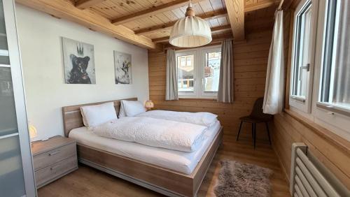 a bedroom with a bed in a wooden cabin at Bergquelle 1.OG Ost in Bettmeralp