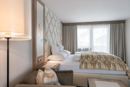 Postel nebo postele na pokoji v ubytování Alpen-Wellness Resort Hochfirst