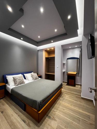 a bedroom with a bed and a flat screen tv at Morfeas apartments in Sarti