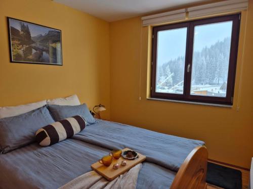 a bedroom with a bed with a tray of food on it at Apartman Savic Jahorina in Jahorina