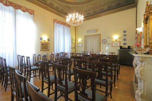 a room with rows of chairs and a chandelier at Hotel Villa Liana in Florence