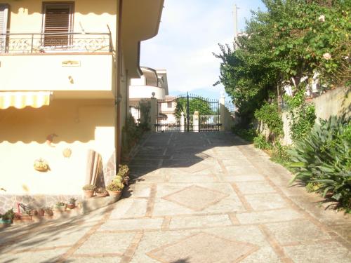 an alley leading to a building with a fence at Sole e Luna Capo Vaticano in Ricadi