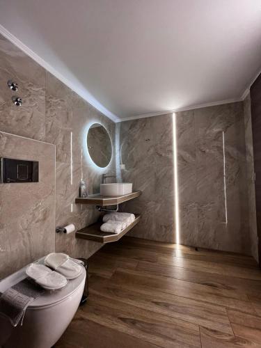 a bathroom with a toilet and a sink at Morfeas apartments in Sarti
