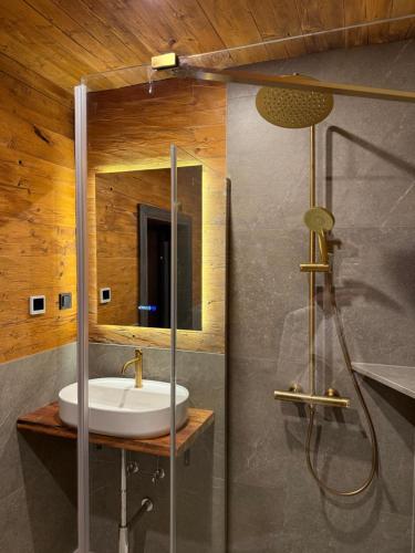 a bathroom with a sink and a shower at Spago am Hochkönig in Mühlbach am Hochkönig