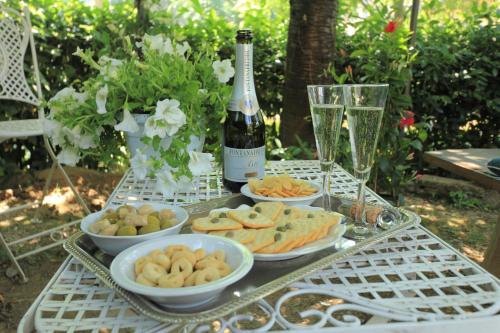 a table with plates of food and a bottle of wine at Hotel Villa Liana in Florence