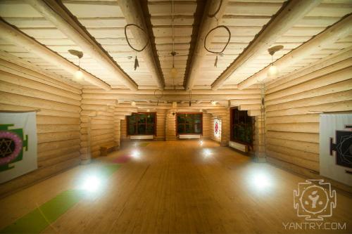 a large room with wooden walls and a wooden floor at Янтри in Dragobrat