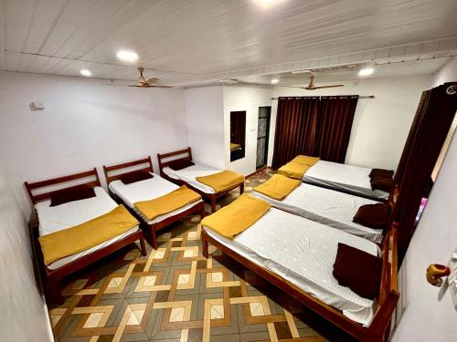 ein Zimmer mit drei Betten in der Unterkunft Siddhi Farm Kolad in Kolad