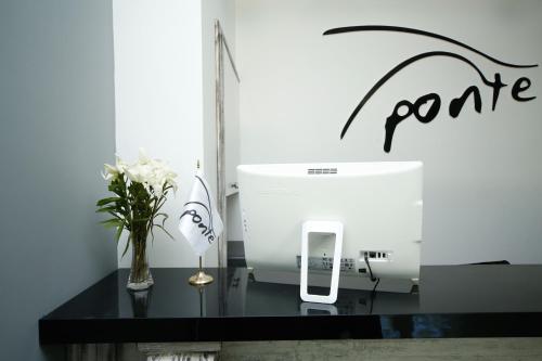 a counter with a flower vase and a sewing machine at Ponte in Kutaisi