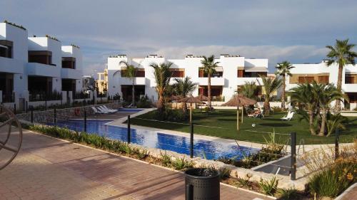a resort with a swimming pool and some buildings at 4daughters Secreto de la Zenia in Playas de Orihuela