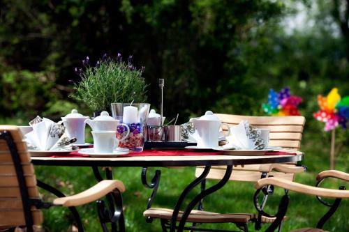 a table with plates and cups on top of it at Hotel Restaurant Anna in Schnelldorf