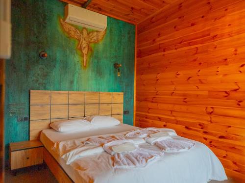 a bedroom with a bed in a wooden wall at Palmera suit in Sapanca