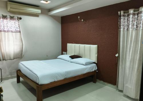 a bedroom with a bed in a room at Geetha Residency in Anantapur