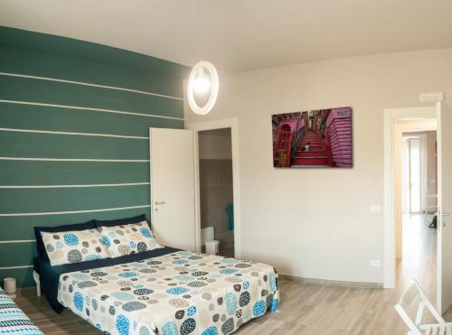 a bedroom with a bed and a green wall at Nelle Stanze Del Matese in Boiano