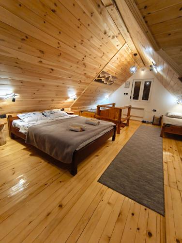 a large room with a bed and wooden floors at Apartmani Božana Vojinović in Žabljak