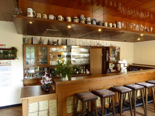 a bar with bar stools at a restaurant at Landgasthof Schneller in Katzwinkel