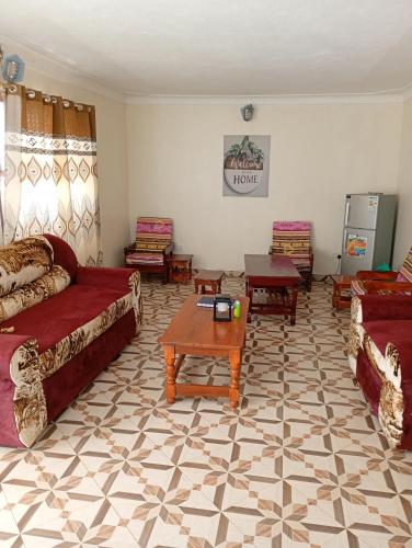 a living room with two couches and a coffee table at The Lakeside Beach Hotel in Busia