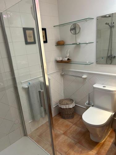 a bathroom with a toilet and a glass shower at Chalet Nº 7 Tajinaste in Puerto del Carmen