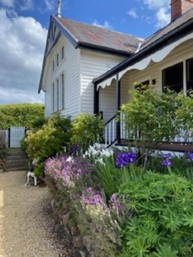 a house with a garden of flowers in front of it at Convent Franklin - Schoolhouse Apartment in Franklin